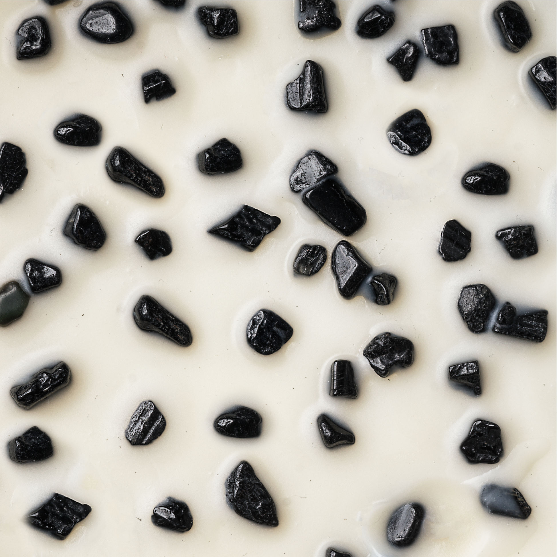 Small pieces of black tourmaline on wax