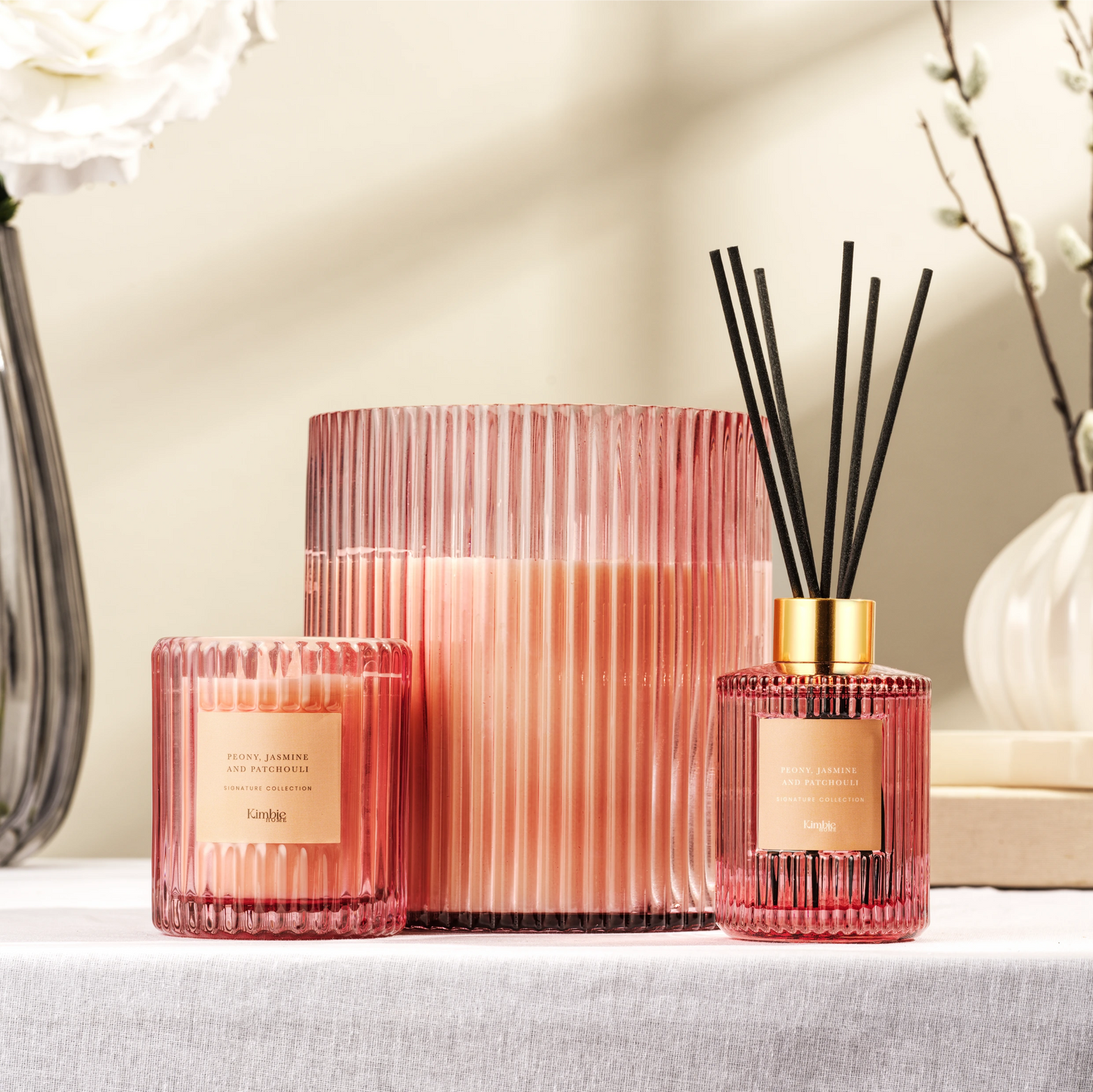 Decorative pink collection of soy wax candles and a natural oil diffuser