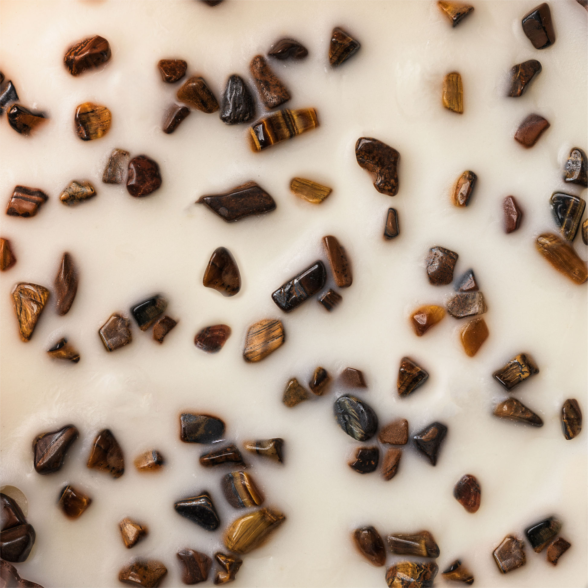 Close-up of small pieces of tigers eye on a white background