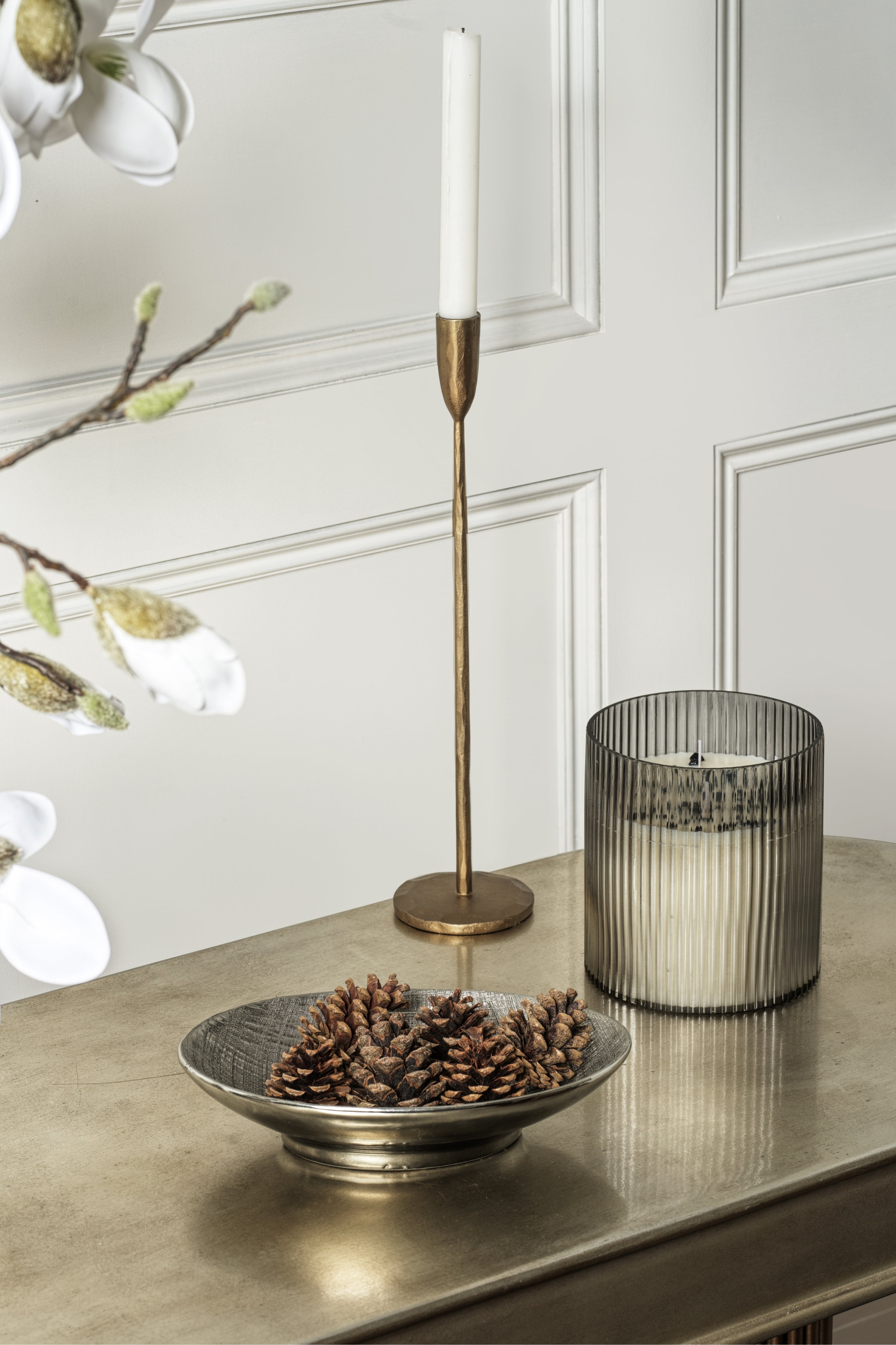 Large kimbie candle featuring black tourmaline on a table with other decor